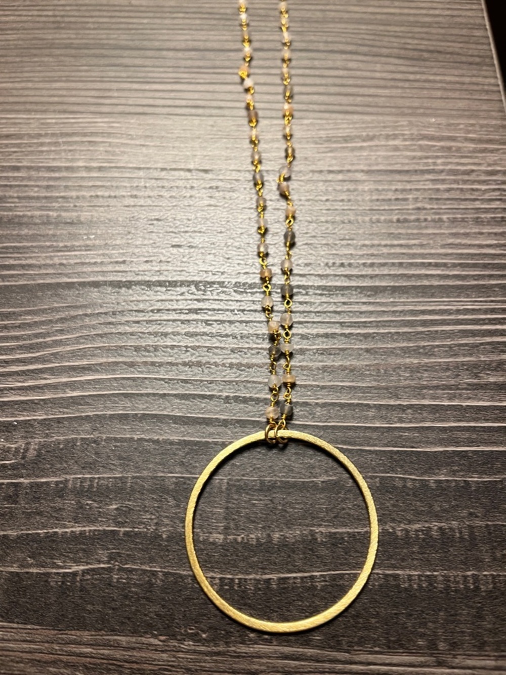 Unbranded gold tone circle pendant necklace.